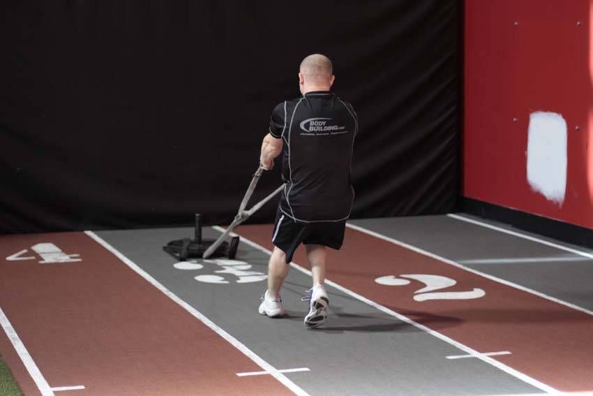 Backward Sled Drag exercise demonstration, targeting the quads