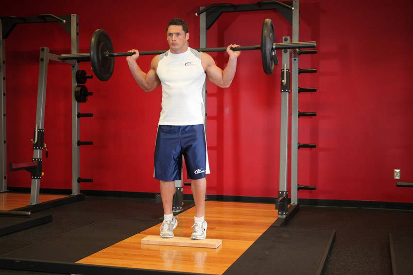 Standing Barbell Calf Raise exercise demonstration, targeting the calves