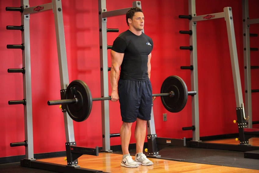 Behind-the-Back Barbell Shrug exercise demonstration, targeting the traps