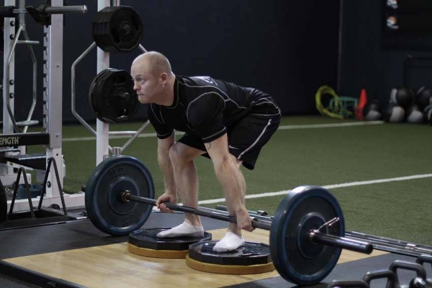 Deficit Deadlift exercise demonstration, targeting the back