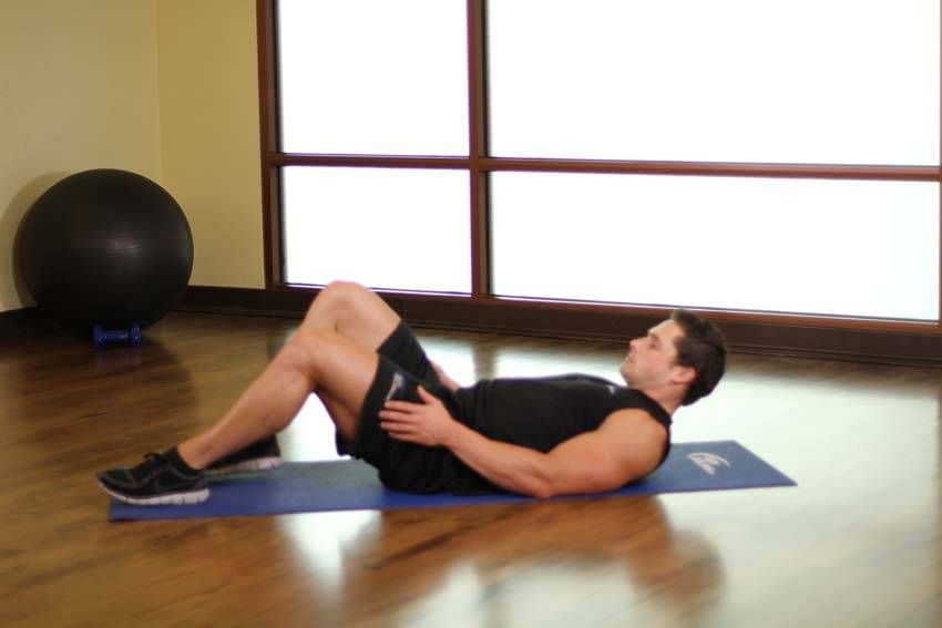 Figure-Four Glute Stretch exercise demonstration, targeting the glutes