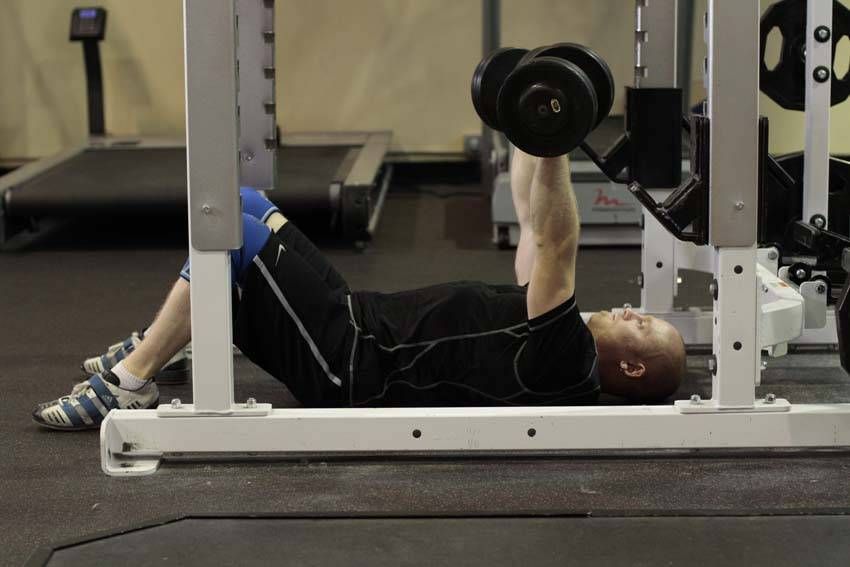 Dumbbell Floor Press exercise demonstration, targeting the chest