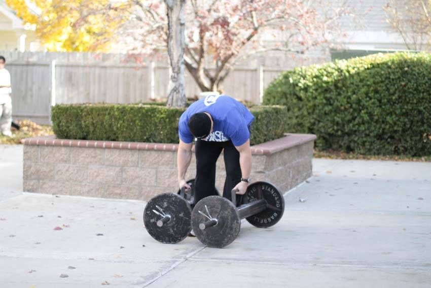 Farmer's Carry exercise demonstration, targeting the forearms