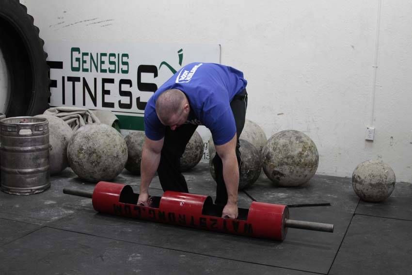 Log Clean and Press exercise demonstration, targeting the shoulders