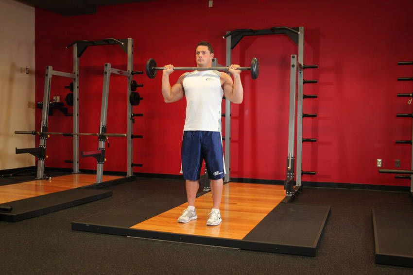 Overhead Press exercise demonstration, targeting the shoulders