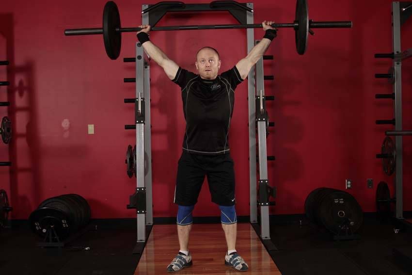 Overhead Squat exercise demonstration, targeting the quads