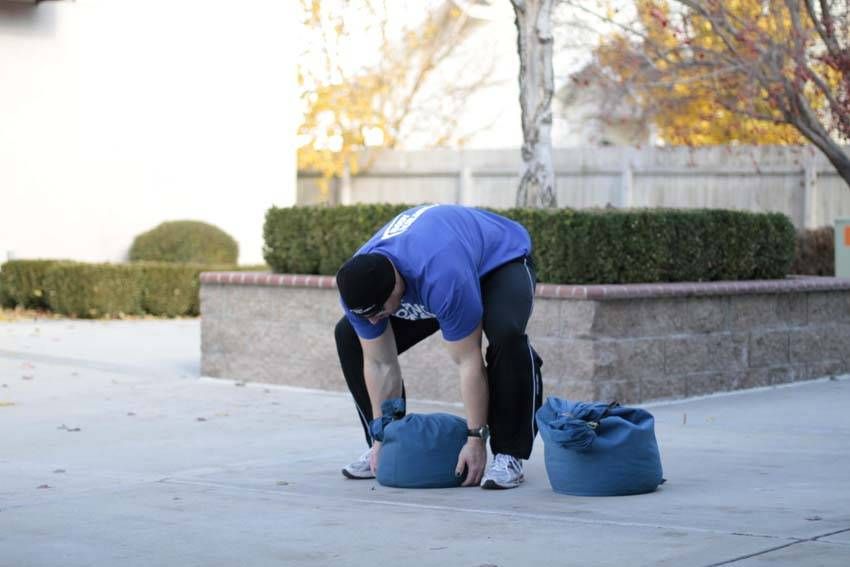 Sandbag Load exercise demonstration, targeting the quads