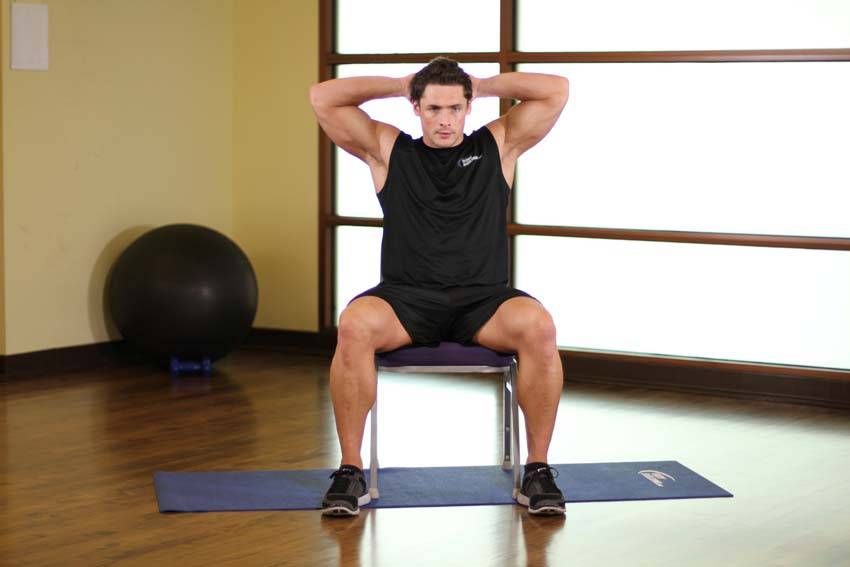 Seated Spinal Twist exercise demonstration, targeting the obliques